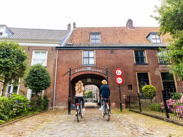 2 fietsers die voor de Kasteelsepoort fietsen
